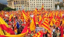 Anti-independentist Catalans hold Catalan and Spanish flags during a